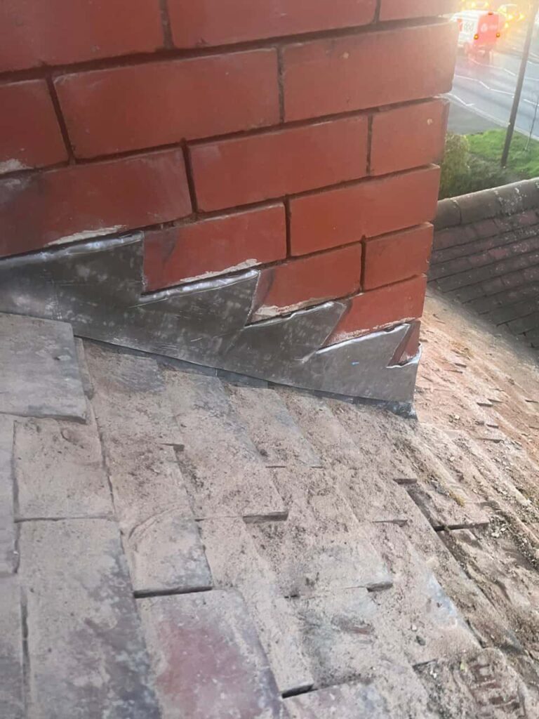 This is a photo of new leadwork being installed around an old chimney. Works carried out by Oldbury Roofing Repairs
